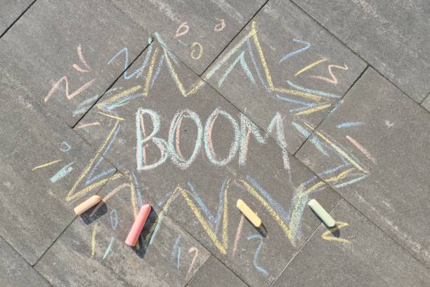 istock Text Boom drawing crayons on gray asphalt 1148007691