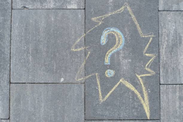 istock Abstract question mark drawn in crayons on gray asphalt 1148007878