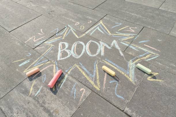 istock Text Boom drawing crayons on gray asphalt 1148007948
