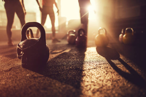Sport equipment in gym. Kettle bell on floor background, Fitness training stock photo