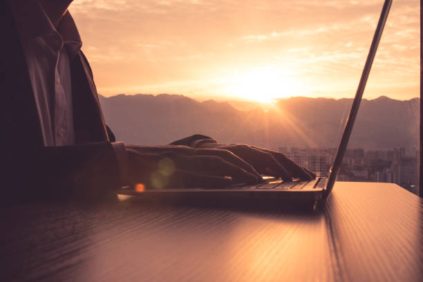 istock Businessman working with laptop at sunset time 1148010639