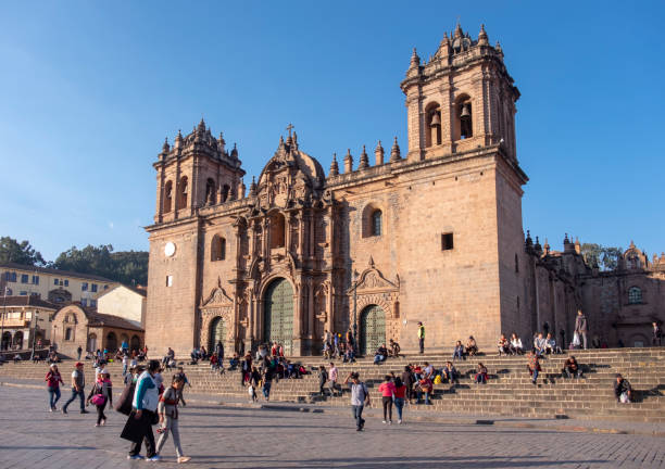Candid Scene Of Pedestrians In The Plaza De Armas Of Cusco, Peru, With The Cathedral In The Background