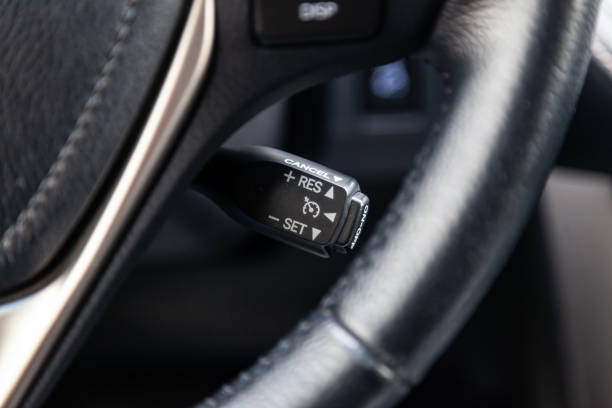 istock The shift lever to set the automatic cruise control speed inside the car close-up located near the steering wheel in black with white signs and symbols of beautiful design in interior. Auto service. 1148010875