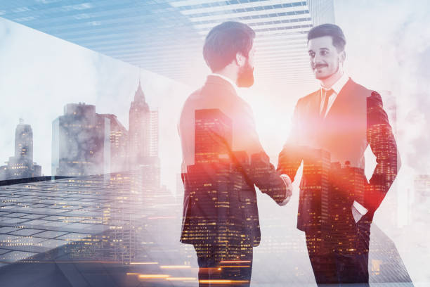 istock Two businessmen shaking hands in city 1148012472