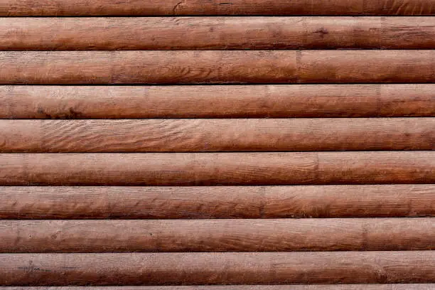 Photo of Background from wooden logs wood texture brown wooden wall