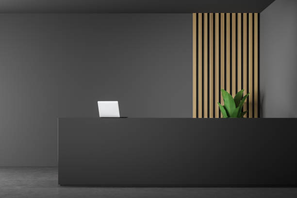 istock Black reception table in gray and wooden office 1148013248