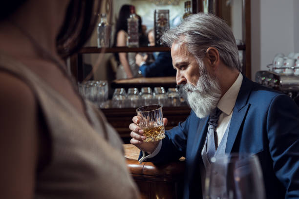 istock Classy dressed senior man sitting in bar 1148013708