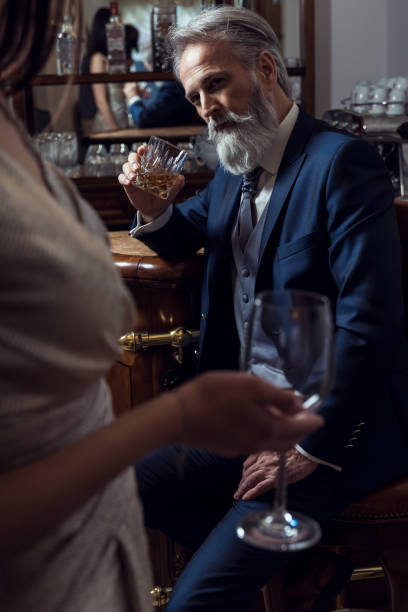 istock Classy dressed senior man sitting in bar 1148013732