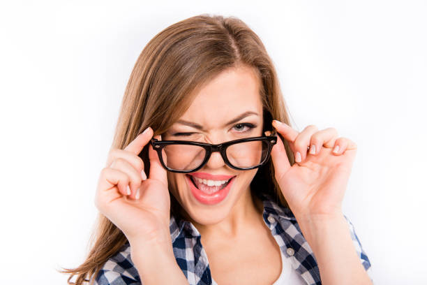 istock Cute girl holding her glasses and smiling 1148013899