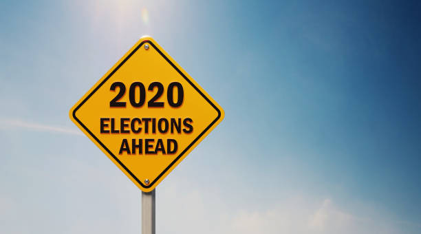 istock Yellow Off Road Traffic Sign With 2020 Elections Ahead Text on Blue Sky 1148013905