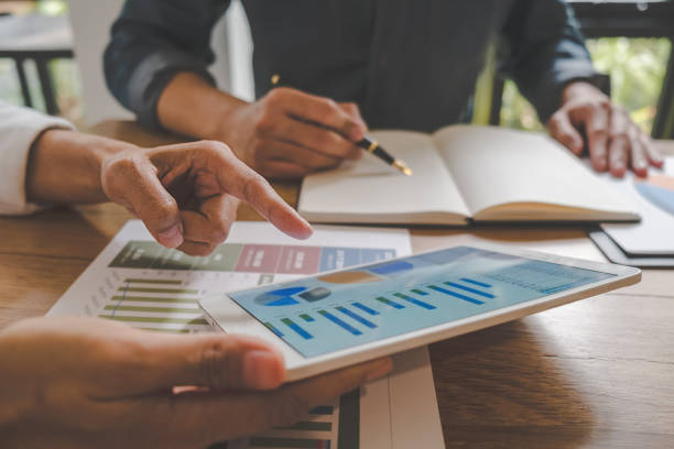 istock Business team brainstorming and discussing with financial data and report graph. Teamwork meeting working concept. 1148014637