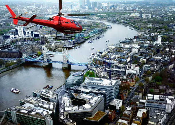 Photo of Helicopter Flying over Tower Bridge, London, UK.