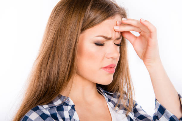 istock Beautiful young woman suffering from headache 1148014865