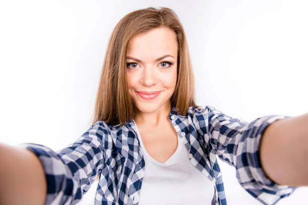 istock Nice-looking cute young woman making selfie photo 1148014921
