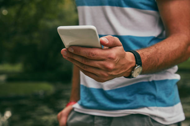 istock Trendy man using cellphone outdoors. 1148015030