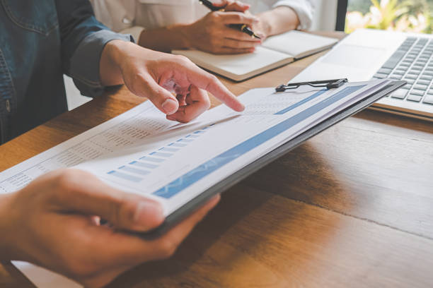 istock Business team brainstorming and discussing with financial data and report graph. Teamwork meeting working concept. 1148015162