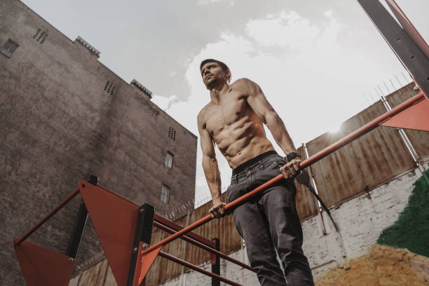 istock Shirtless athlete practicing calisthenics with smartwatch on his wrist 1148016188
