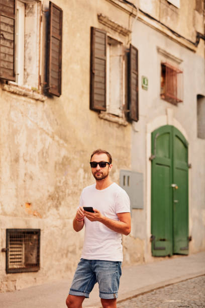 istock Modern guy using cellphone in the European city. 1148016294