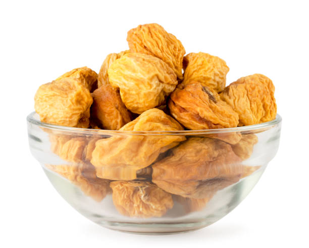 istock Dried apricot with a bone in a glass plate on a white, isolated. 1148016631