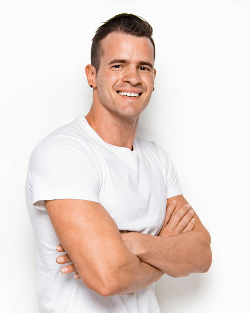 istock Handsome man wearing white shirt with arms crossed 1148018227