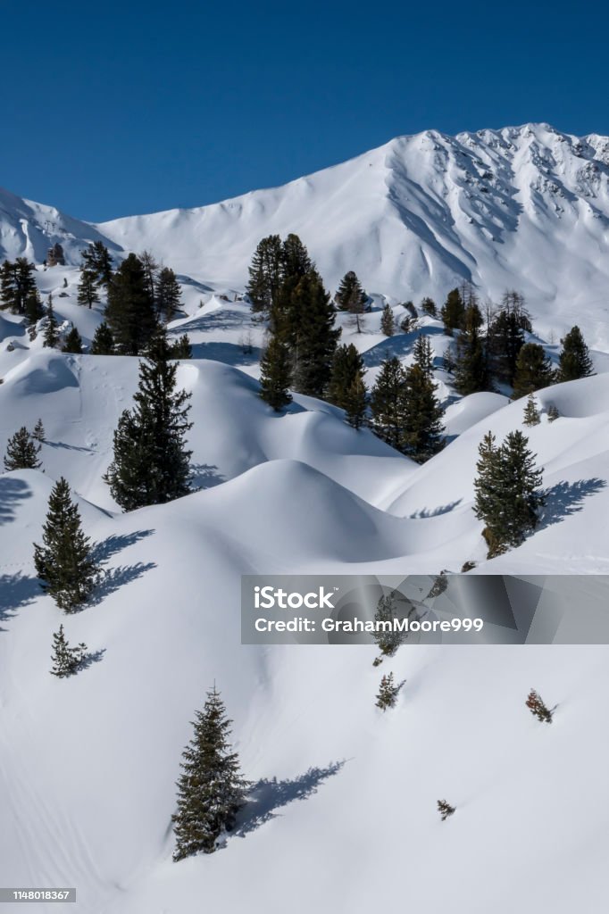 Undulating snowy mountainscape undulating snow covered landscape above la plagne french alps La Plagne Stock Photo