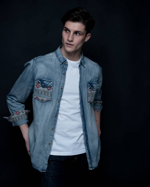 istock Close up view of attractive man wearing a button down shirtt and is on black background 1148018542