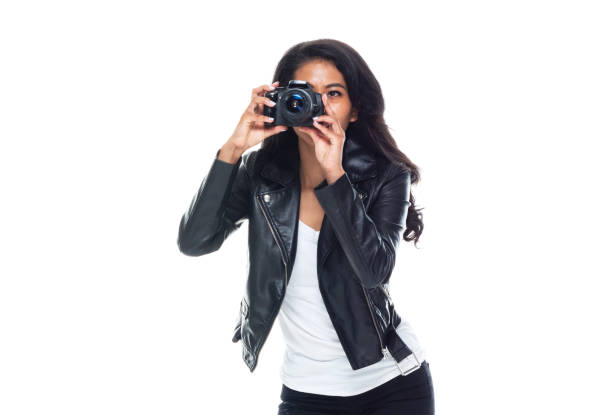 istock Bautiful woman wearing a leather jacket sitting and using a DSLR camera 1148020008