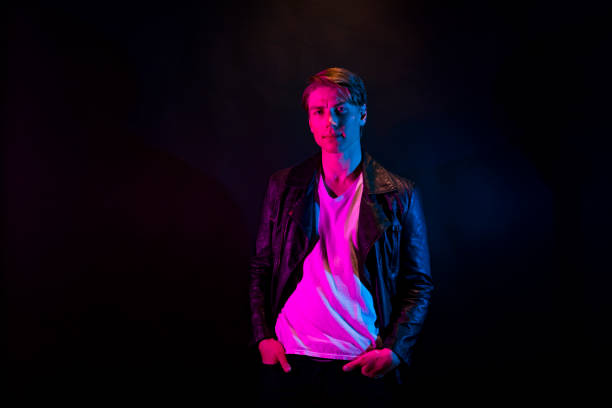 istock Sexy man wearing leather jacket with blue and red light 1148020046