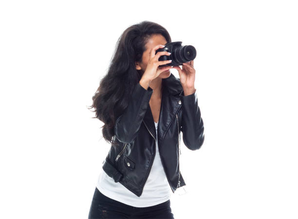 istock Bautiful woman wearing a leather jacket sitting and using a DSLR camera 1148020252