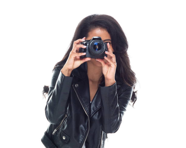 istock Bautiful woman wearing a leather jacket sitting and using a DSLR camera 1148020260