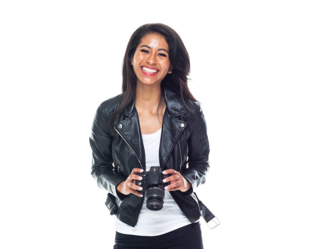 Bautiful woman wearing a leather jacket sitting and using a DSLR camera