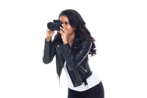 istock Bautiful woman wearing a leather jacket sitting and using a DSLR camera 1148020295