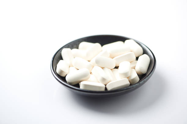 GABA (GAMMA-AMINOBUTYRIC ACID) Tablets. Concept for a healthy dietary supplementation. White background. Copy space.