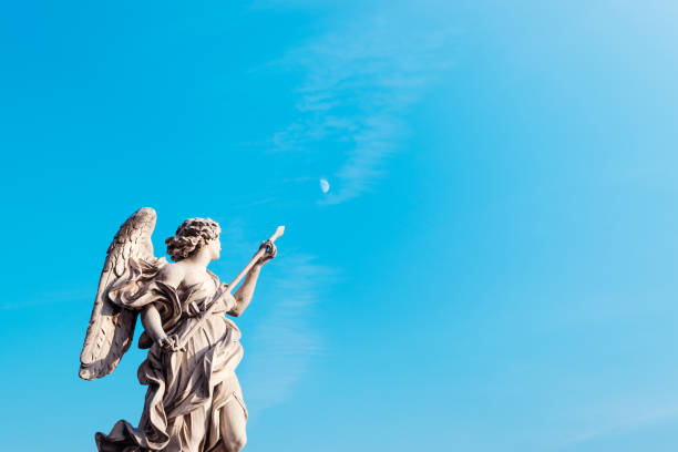 The statue of an angel on Ponte Sant'Angelo in Rome indicates the moon in the sky by day with a spear stock photo