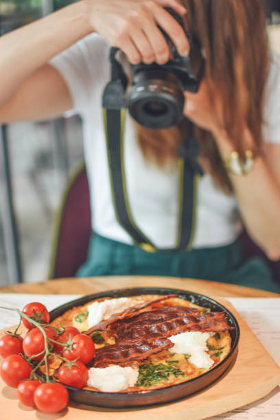 istock Female hands taking picture of breakfast table set up 1148027807