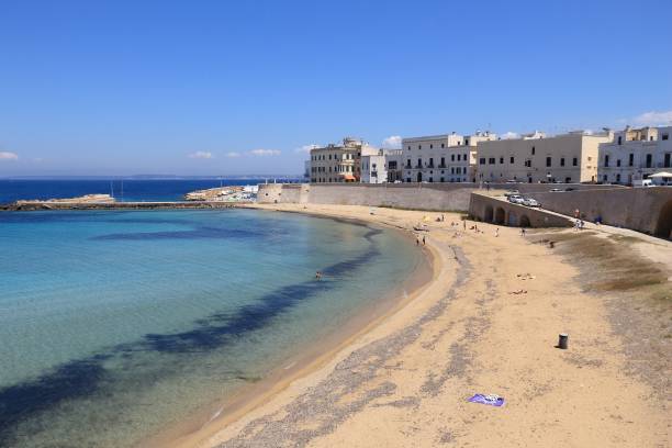 Gallipoli, Italy, 07/15/2024. People on the beach in a tourist town in the province of Lecce.