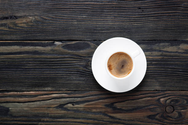 istock Fresh and aromatic coffee in a white cup on an old wooden table. Top view 1148030399