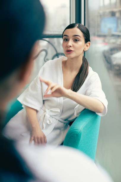 istock Gesturing woman looking at her friend while talking to her 1148031781