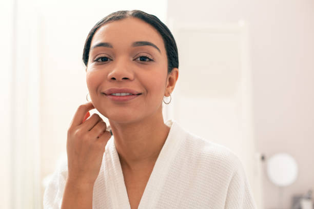istock Cheerful woman smiling and touching her face 1148033953