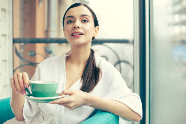 istock Thoughtful woman with tea looking into the distance 1148034183