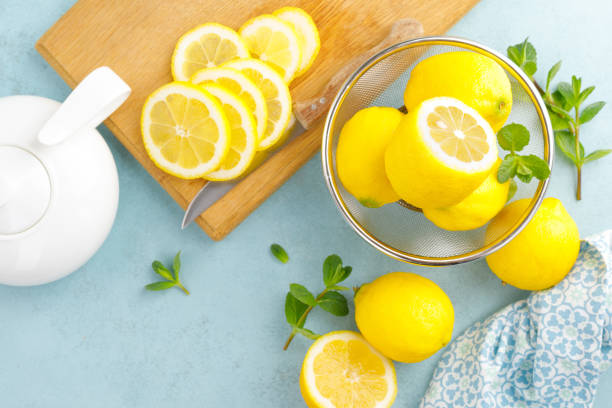istock Sliced and whole lemons with mint 1148035153