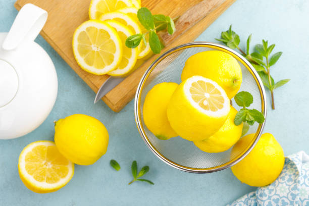 istock Sliced and whole lemons with mint 1148035758