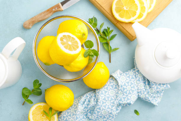 istock Sliced and whole lemons with mint 1148038259