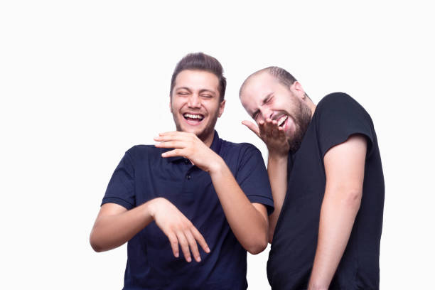 Friends laughing and enjoying over white background. Horizontal composition. Studio shot.