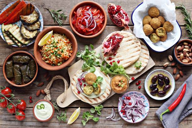 Middle eastern, arabic or mediterranean appetizers table concept Middle eastern, arabic or mediterranean appetizers table concept with falafel, pita flatbread, bulgur and tomato salads, grilled vegetables, stuffed grape leaves,olives and nuts. mediterranean food photos stock pictures, royalty-free photos & images