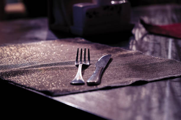 istock A fork and a knife on the table on a dark napkin 1148040188