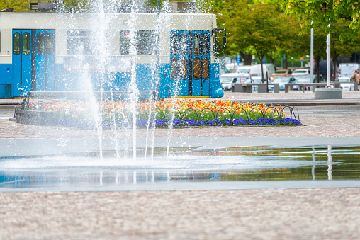 Fountain in front of flowerbed and Gothenburg tram