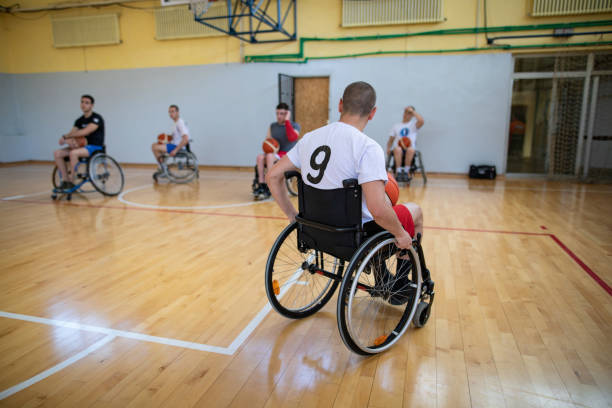 istock Determined basketball players in wheelchairs training together 1148042007