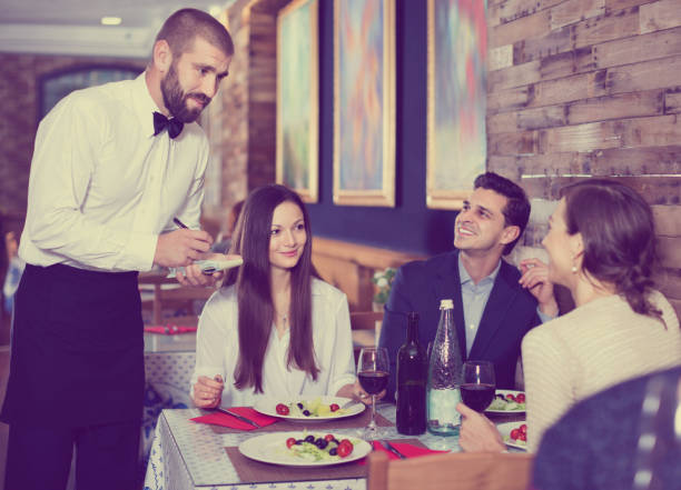 istock Waiter with notebook taking order from friendly company indoors 1148042198