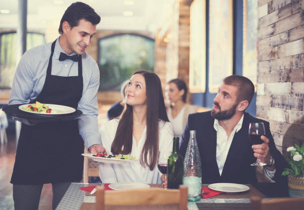 istock waiter man serving company at restaurant 1148042211